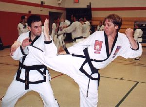 students practice kick defenses